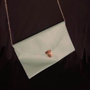 Seafoam clutch with gold accents and optional strap.  7”x11”. Vegan leather.
